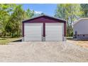 Large two car detached garage with two roll-up doors and parking outside on a gravel drive at 254 Nelson Farm Ln, Cross, SC 29436