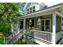 Charming two-story home with a welcoming front porch and beautiful light fixtures at 29 Morrison Ave, McClellanville, SC 29458