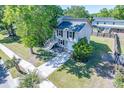 Overhead view of the home, manicured lawn, driveway, and lush landscaping showcasing curb appeal at 2920 Newport Pl, North Charleston, SC 29420
