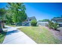 Well-maintained front yard with a neatly trimmed lawn, sidewalk access, and mature landscaping at 2920 Newport Pl, North Charleston, SC 29420