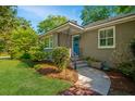 Inviting front porch with brick walkway, stone steps and charming landscaping at 3 Lord Ashley Dr, Charleston, SC 29407