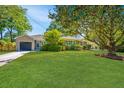 Beautiful home with lush green lawn, shade trees, and a single-car garage at 3 Lord Ashley Dr, Charleston, SC 29407