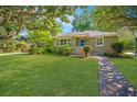 Beautiful home with brick walkway, manicured lawn, and shade trees at 3 Lord Ashley Dr, Charleston, SC 29407