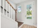 Bright foyer with wood stairs and a clear view to the outdoors at 354 Claret Cup Way, Charleston, SC 29414