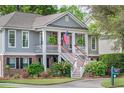 Two story home with gray siding, brick accents, an inviting front porch, and mature landscaping at 3567 Somerset Hills Ct, Mount Pleasant, SC 29466