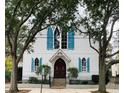 Beautiful white home with blue shutters and a wrought iron fence at 41 Pitt St, Charleston, SC 29401