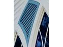 Close up of custom vent in the top arch of a lancet window at 41 Pitt St, Charleston, SC 29401