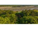 Beautiful aerial view of a home nestled amongst trees and waterways in a scenic marsh at 4386 Park Island Rd, Hollywood, SC 29449