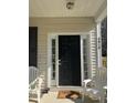 Inviting front porch with a black door, white trim, and comfortable seating, creating a welcoming entrance at 4816 Cane Pole Ln, Summerville, SC 29485