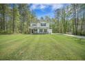 Inviting two-story home with black shutters, lush lawn, and attached two-car garage at 5005 Buckland Trl, Ridgeville, SC 29472