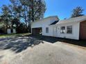 Back view of home with large carport and storage shed, offering convenient parking and storage at 502 May St, Saint George, SC 29477