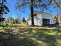 View of the large backyard with mature trees, perfect for outdoor entertaining and Gathering activities at 502 May St, Saint George, SC 29477