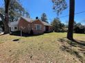Single-story brick home with a large yard perfect for outdoor activities and enjoying the surrounding scenery at 502 May St, Saint George, SC 29477