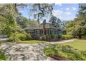 Beautiful home exterior showcases a manicured lawn, lush landscaping, and a welcoming driveway at 503 W Carolina Ave, Summerville, SC 29483