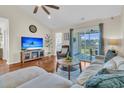 Cozy living room featuring hardwood floors, a ceiling fan, and sliding doors to a screened patio at 5033 Carrington Ct, Summerville, SC 29485