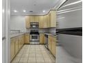 Well-lit kitchen features stainless steel appliances, granite countertops, and light wood cabinets at 5554 Colonial Chatsworth Cir, North Charleston, SC 29418