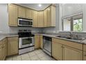 Bright kitchen boasts stainless steel appliances, granite countertops, and light wood cabinetry at 5554 Colonial Chatsworth Cir, North Charleston, SC 29418
