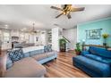 Open-concept living room featuring hardwood floors, a ceiling fan, and a comfortable seating area at 571 Mclernon, Johns Island, SC 29455