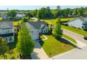 Beautiful aerial view of home with lush green lawn and professional landscaping in quiet neighborhood at 7601 Stargazer Dr, Hanahan, SC 29410