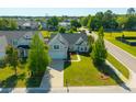 Great aerial shot of home with solar panels, lush green lawn, and professional landscaping at 7601 Stargazer Dr, Hanahan, SC 29410