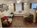 Cozy living room with hardwood floors, decorative rug, and comfortable furnishings at 8634 Grassy Oak Trl, North Charleston, SC 29420