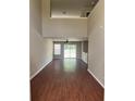Spacious living room featuring high ceilings, hardwood floors, and sliding glass doors to the backyard at 9032 Maple Grove Dr, Summerville, SC 29485