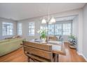 Bright dining area boasts hardwood floors and ample natural light from multiple windows at 9042 Parlor Dr, Ladson, SC 29456