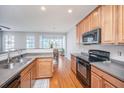 Open kitchen featuring stainless steel appliances, ample cabinet space, and hardwood flooring at 9042 Parlor Dr, Ladson, SC 29456
