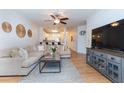 Bright living room featuring a large sofa, modern decor, and an open floor plan at 1025 Riverland Woods Pl # 906, Charleston, SC 29412
