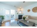 Cozy living room with a fireplace, stylish decor, and access to an outdoor balcony at 1025 Riverland Woods Pl # 906, Charleston, SC 29412