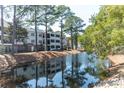 Scenic waterfront view of the community, featuring lush landscaping and inviting walking paths at 1025 Riverland Woods Pl # 906, Charleston, SC 29412