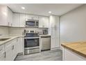 Bright kitchen featuring stainless steel appliances, white cabinets, and ample counter space at 14 Lockwood Dr # 11H, Charleston, SC 29401