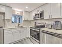 Modern kitchen with stainless steel appliances, white cabinets, and subway tile backsplash at 14 Lockwood Dr # 11H, Charleston, SC 29401