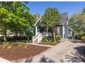 Charming home featuring manicured landscaping and a neatly maintained gravel driveway at 1516 Village Sq, Mount Pleasant, SC 29464