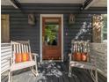 Inviting front porch with rocking chairs and decorative lanterns flanking the entry door at 1516 Village Sq, Mount Pleasant, SC 29464