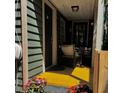 Inviting front porch features wicker seating and pops of floral color, adding charm at 152 Coming St St, Charleston, SC 29403