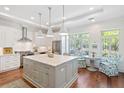 Bright, spacious kitchen with a large island, modern stainless steel appliances, and a charming breakfast nook at 155 Wingo Way # 415, Mount Pleasant, SC 29464