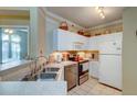 Bright kitchen featuring white cabinets, stainless steel appliances, and tile flooring at 1832 Telfair Way # 1832, Charleston, SC 29412