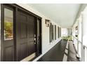 Inviting front porch featuring a black door, light blue ceiling, and classic white columns at 193 Corn Planters St, Charleston, SC 29492