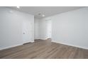 Large, open living area with light wood floors, white walls, and views of multiple doorways at 202 W Bradford Pointe Drive Dr, Summerville, SC 29483