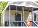 Close-up of the home's front porch featuring seating, a wind chime, and the house number at 2125 Victory Ave, North Charleston, SC 29405
