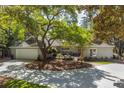 Beautiful home with a circular driveway, mature trees, and a well-maintained lawn at 2575 The Haul Over, Seabrook Island, SC 29455
