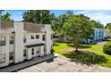 An aerial view shows assigned parking and the front exterior of a two-story townhouse unit at 259 Pine Shadow Dr, Goose Creek, SC 29445