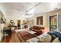 Bright living room with hardwood floors, ceiling fan, tapestry, and access to outdoor space at 2808 Ion Ave, Sullivans Island, SC 29482