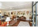 Cozy living room boasts hardwood floors, a ceiling fan, stylish rugs, and natural light at 2808 Ion Ave, Sullivans Island, SC 29482
