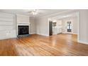 Open-concept living space with hardwood floors, fireplace, and seamless flow into adjacent updated kitchen at 298 Summerset Ln, Summerville, SC 29483