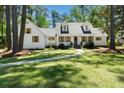 Charming white home with shuttered windows features a curved walkway leading to the front entrance at 309 Huntington Rd, Summerville, SC 29483