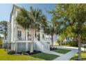 Side angle of a two-story house with a covered porch and lush landscaping at 4082 Blackmoor St, Mount Pleasant, SC 29466
