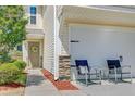 Charming home entrance with a two-car garage and inviting front door at 409 Thoroughbred Dr, Moncks Corner, SC 29461