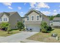 A charming house with a two-car garage and beautiful front yard landscaping at 409 Thoroughbred Dr, Moncks Corner, SC 29461